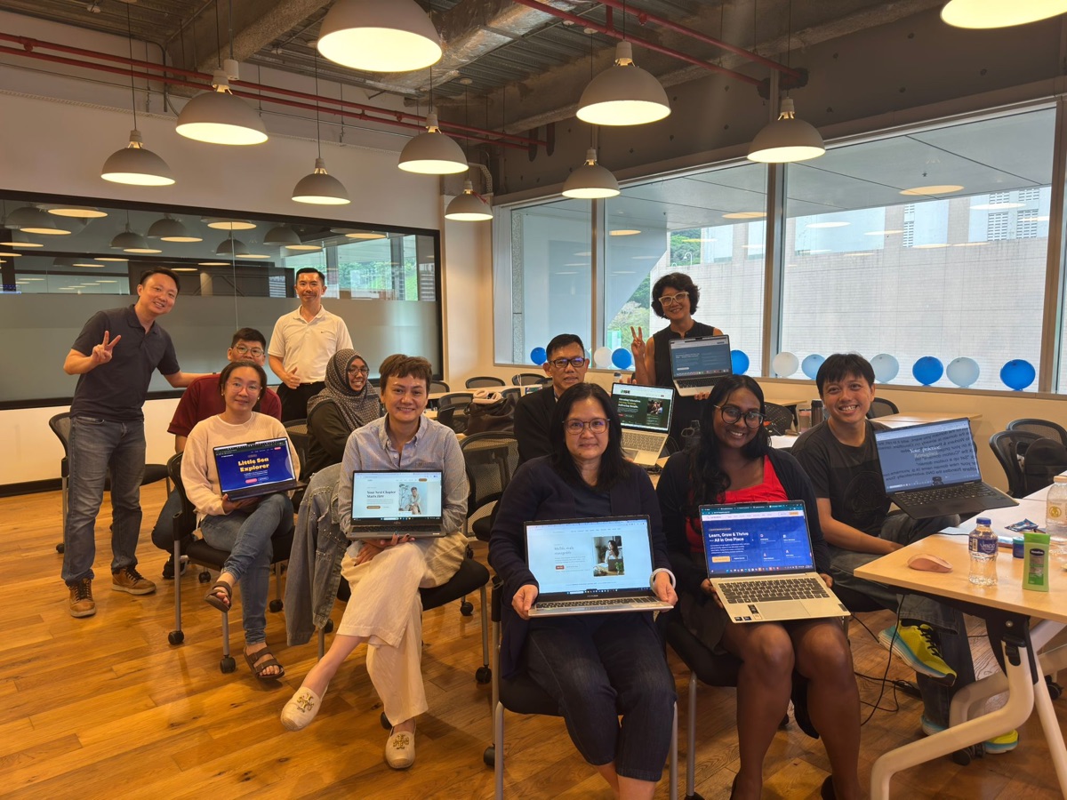 Keith with the 23 April 2026 cohort at ERC Institute, students holding up their completed websites